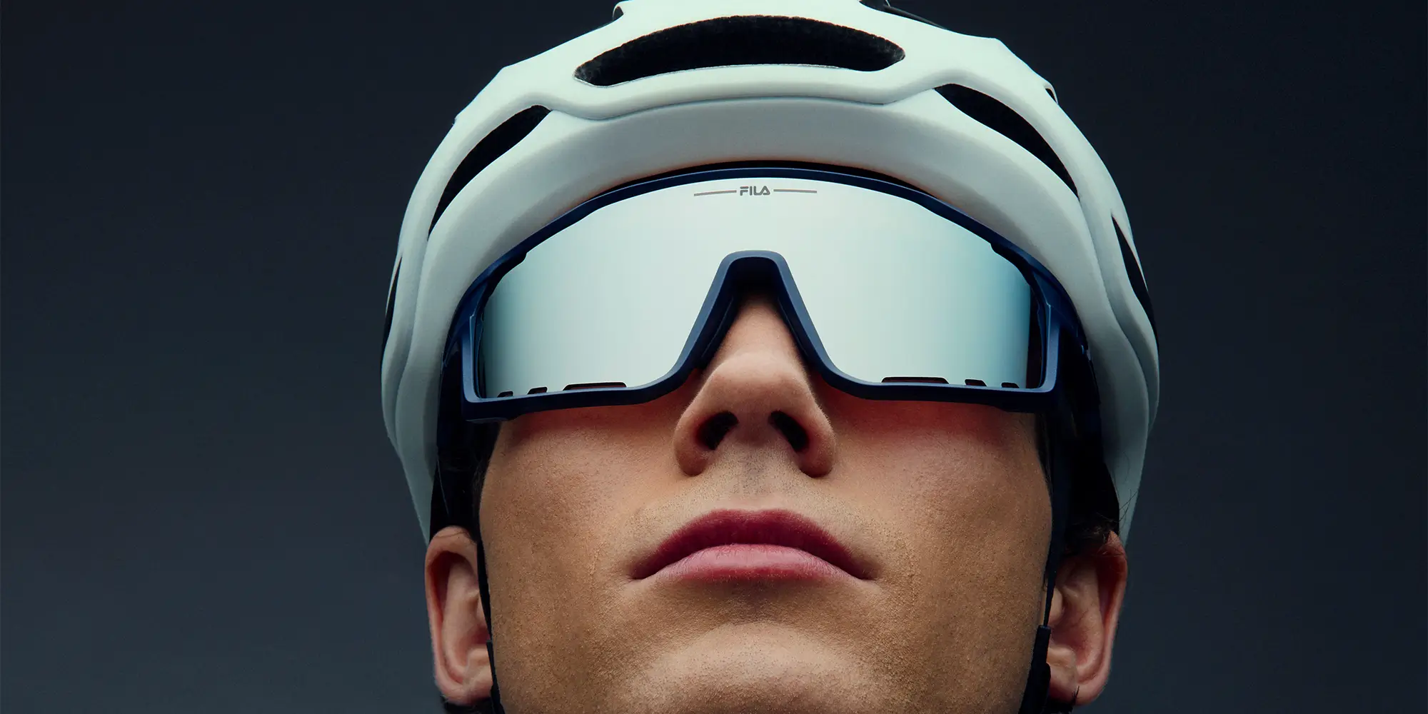 Man and woman in sport sunglasses with mirrored purple and orange polarized lenses.